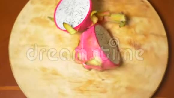 餐桌上的异国水果火龙果切成块在砧板上旋转视频的预览图