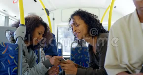 商务通勤者乘坐4k公交车时使用手机视频的预览图