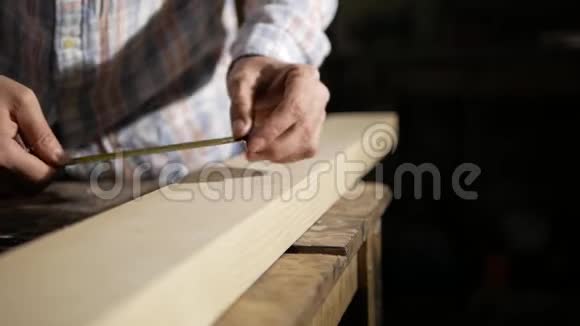 一个人用卷尺测量一块木板视频的预览图