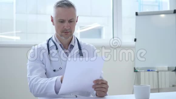 医生在诊所阅读医疗文件视频的预览图