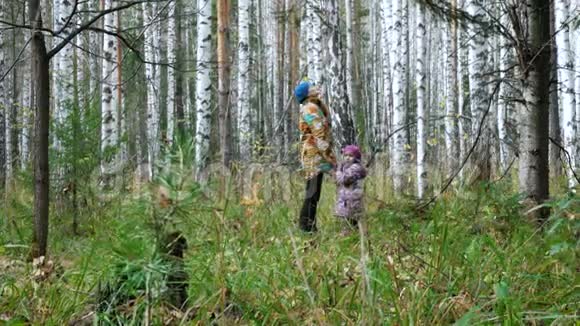 妈妈和她的小女儿正在森林里散步视频的预览图