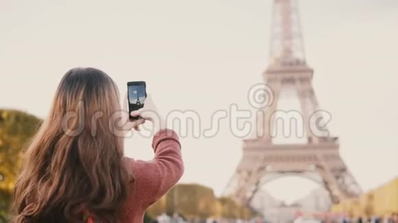 年轻的黑发女性在智能手机上拍摄埃菲尔铁塔的照片探索法国巴黎的青少年视频的预览图