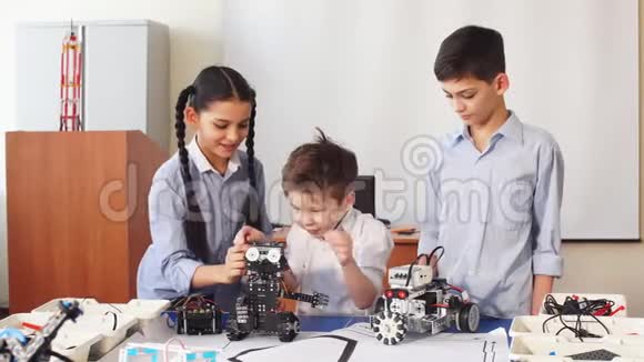 一群孩子在学校课上选择机器人玩具的部件来制造机器人视频的预览图
