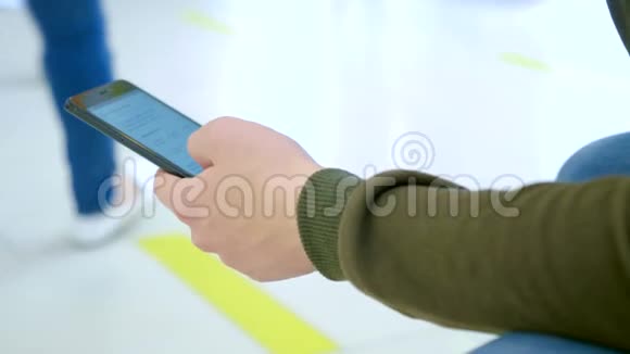 一个年轻人在购物中心使用手机视频的预览图
