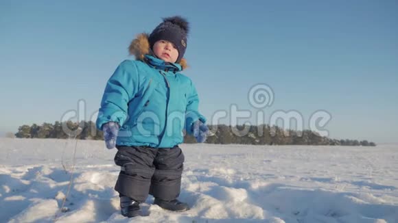 冬天特写户外可爱梦幻的小男孩肖像快乐的小男孩在雪地里玩耍户外视频的预览图