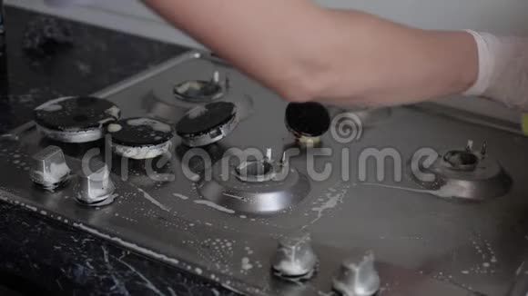 使用海绵清洁厨房灶具时女性手戴手套视频的预览图