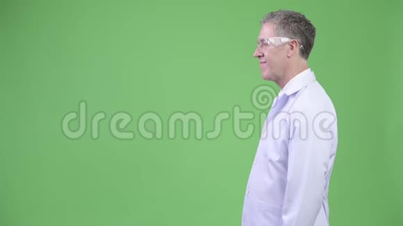 戴防护眼镜的快乐成熟男医生的侧写视频的预览图