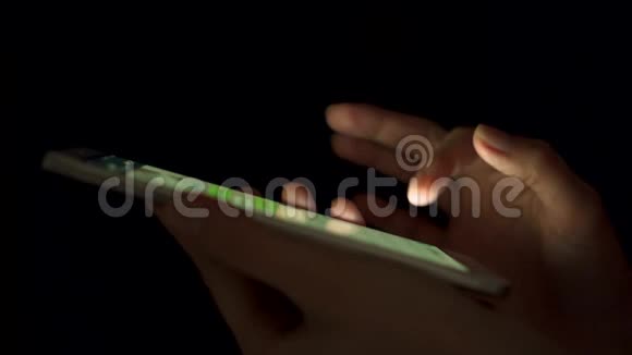 夜间在室内使用智能手机触摸屏的女性手部特写输入信息视频的预览图