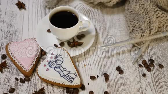 夫妻关系圣瓦伦丁节日概念一杯咖啡和姜饼干上面有针织针和纱线视频的预览图