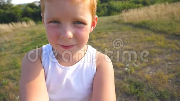 英俊的婴儿饶有兴趣地看着他手中的相机密切男性儿童的情绪视频的预览图