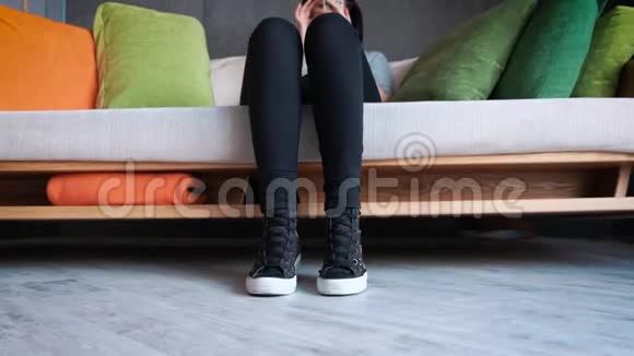 阁楼风格的现代化办公室一个穿运动鞋的女孩坐在沙发上在秋千上摆动视频的预览图