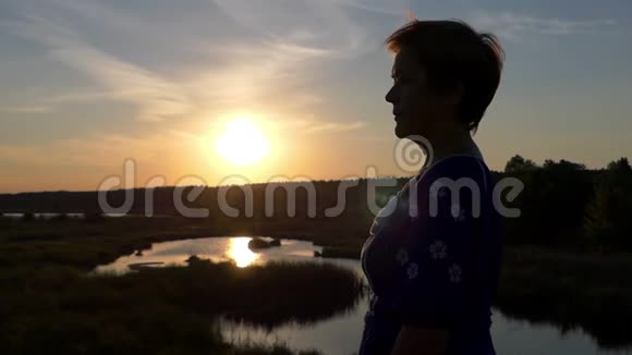 夕阳西下美丽的女人戴上太阳镜视频的预览图
