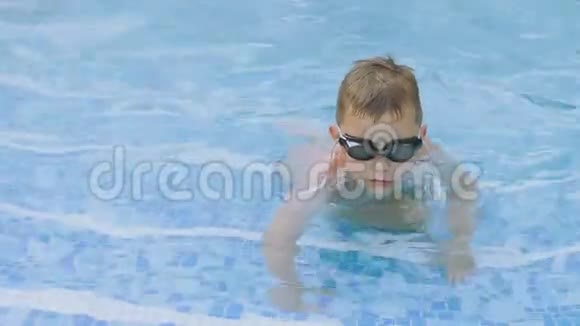 戴眼镜的男孩在游泳池游泳视频的预览图