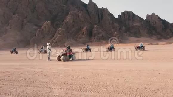 在沙漠中驾驶的四轮自行车赛车团体视频的预览图