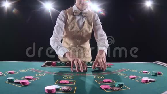 赌场赌局的女人把扑克牌混在一起用纸牌表演魔术黑色背景明亮的灯光慢慢视频的预览图
