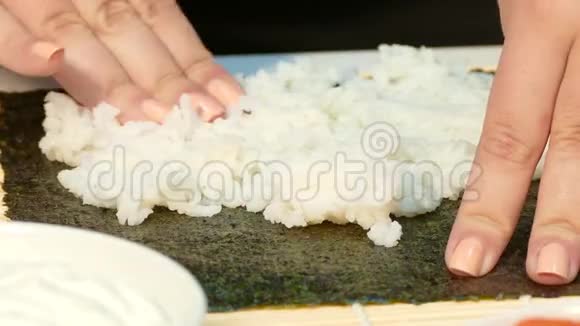 厨师双手揉捏诺丽床单上的米饭视频的预览图