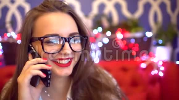 女人在智能手机上说话在咖啡馆里笑漂亮的年轻女性专业人士在手机上随意交谈视频的预览图