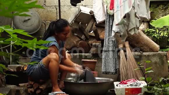 家庭主妇在不整洁的后院洗衣服视频的预览图