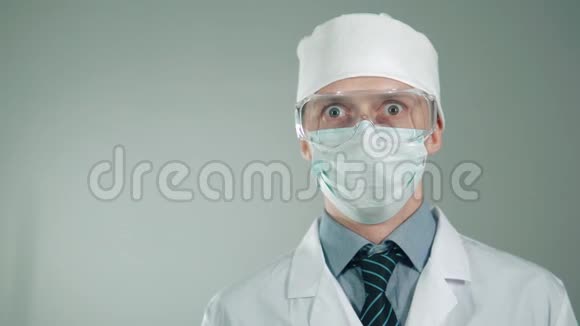非传统的治疗方法医生灌肠并微笑防护面罩和眼镜奇怪的医生视频的预览图