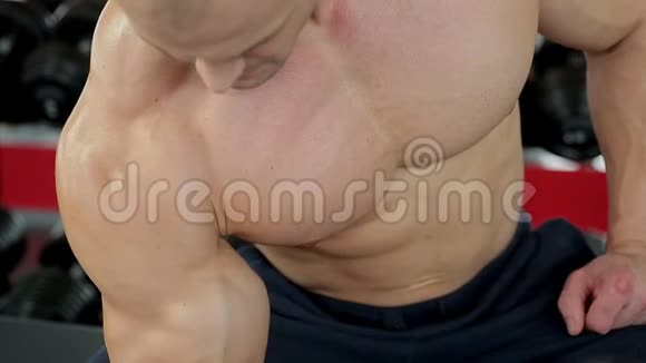肌肉发达男子健身操哑铃操的特写镜头视频的预览图
