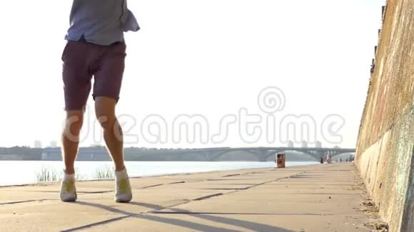 男子腿舞在河岸上的迪斯科与夏天的高石墙在斯隆莫视频的预览图