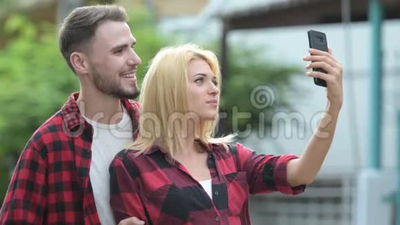 年轻快乐的情侣在户外的街头打电话视频的预览图