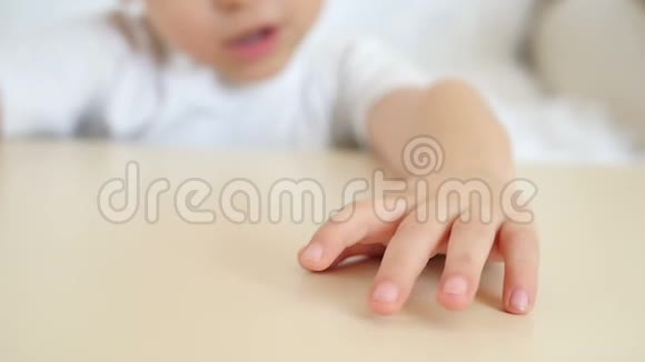 一个孩子在桌子上展示他的双手特写视频的预览图