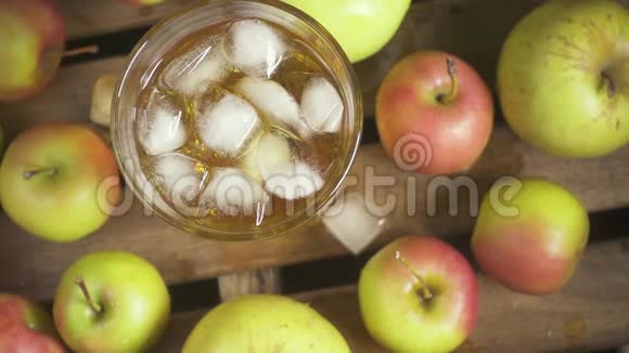 一只雌性手拿着一杯果汁和一个苹果慢动作视频的预览图
