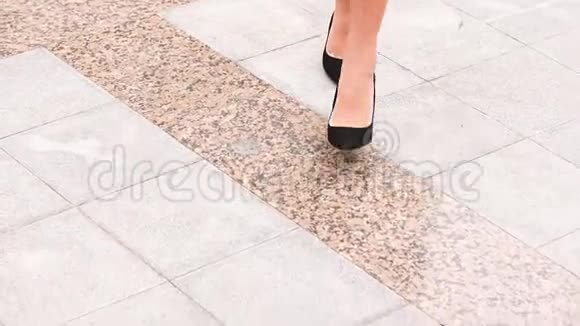 双腿黑色高跟鞋在城市街道上行走视频的预览图