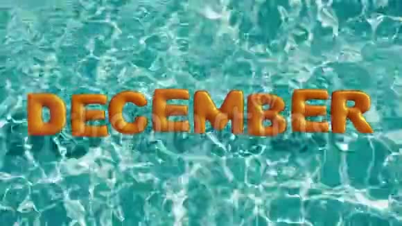 单词十二月形状的充气游泳圈漂浮在一个清爽的蓝色游泳池里视频的预览图