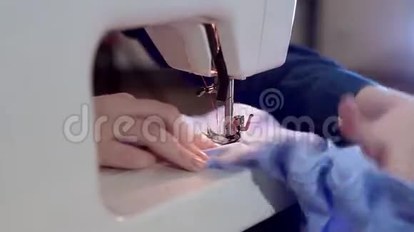 特写女手在缝纫机上她缝衣服针扎缝视频的预览图
