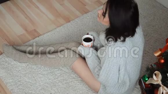 穿毛衣的可爱女孩手里拿着一杯咖啡视频的预览图