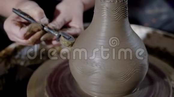 一位大师用特殊的乐器装饰粘土花瓶视频的预览图