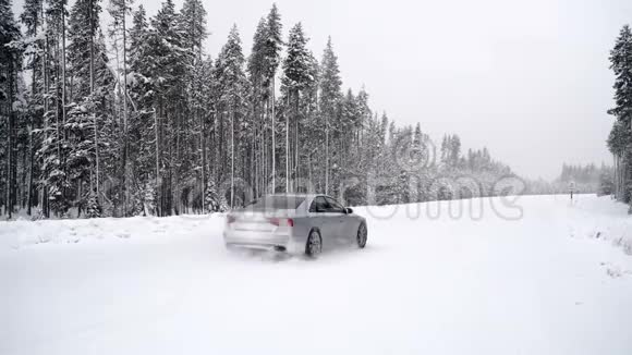 一辆汽车在森林道路上大雪时经过视频的预览图