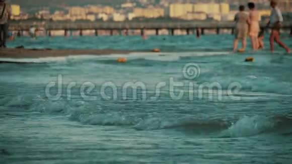 大海滩上巨浪人在后台游泳视频的预览图
