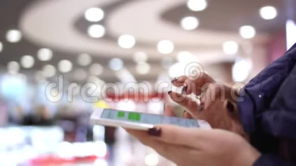 那个女人手里拿着智能手机使用触摸屏近距离观看女性手握智能手机视频的预览图