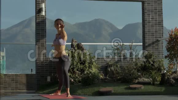 女孩站在山顶露台上做瑜伽视频的预览图