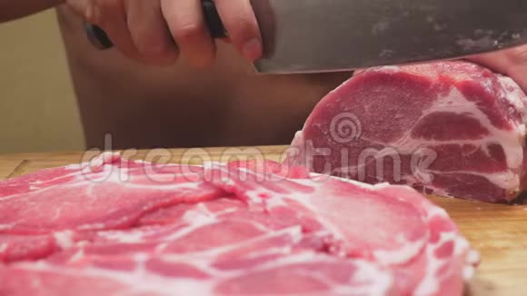 一个赤裸躯干的男人用刀子缓慢地切割生肉4k特写视频的预览图