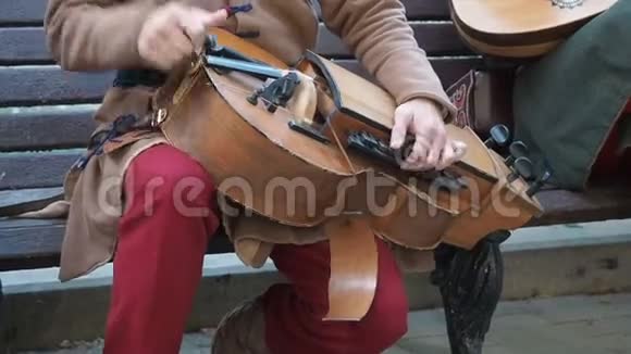 街头音乐家身着古老的东方民族服饰演奏传统中东乐器的音乐视频的预览图