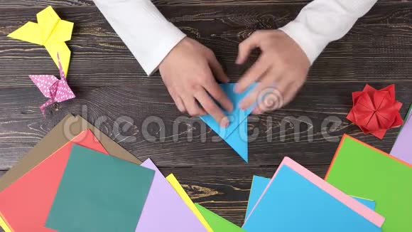 手形成蓝色折纸鹤视频的预览图