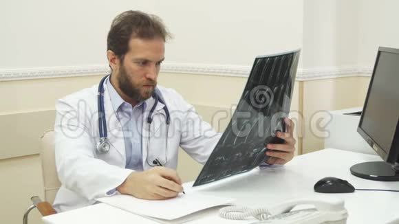 医生在检查X射线后正在写一份建议视频的预览图