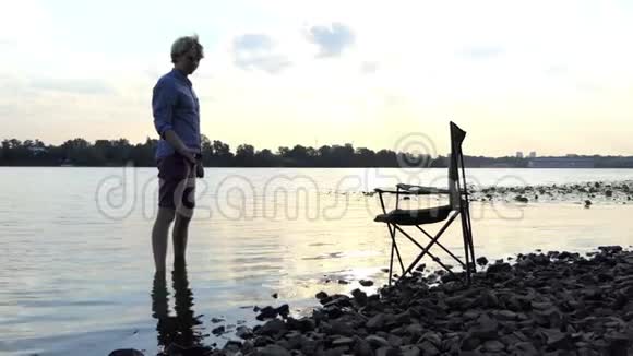 光着脚站在河岸边的水中还有斯隆莫的石头视频的预览图