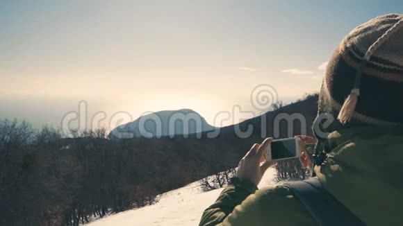 Hiker女孩用她的智能手机4k拍摄野生冬季大自然视频的预览图