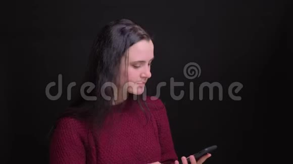 年轻美丽的白种人女性的特写镜头黑发在手机上自拍背景是孤立的视频的预览图