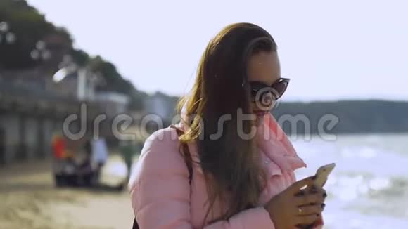 年轻女子在海上射击智能手机视频的预览图