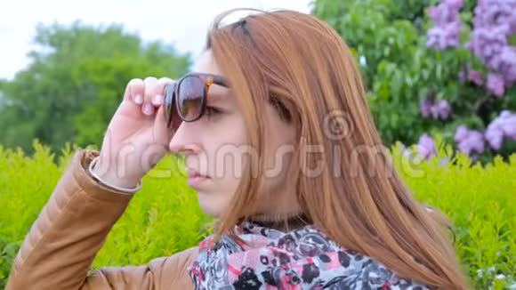 不满意的女孩看人公园里戴太阳镜的女人视频的预览图