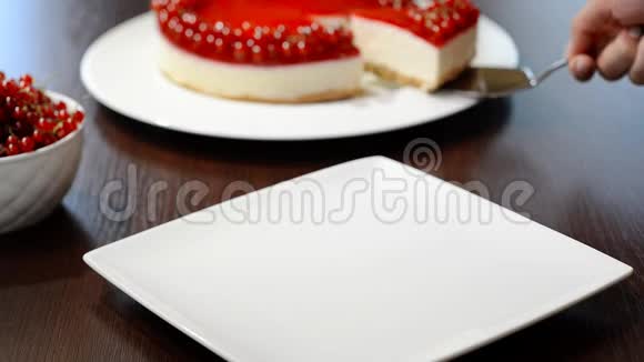 把一块加红醋栗的芝士蛋糕放在白色盘子里视频的预览图