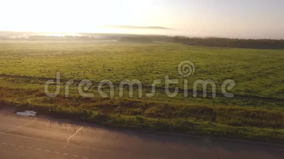 早晨在风景如画的绿茵场上近距离观看高速公路录像景观与乡村视频的预览图
