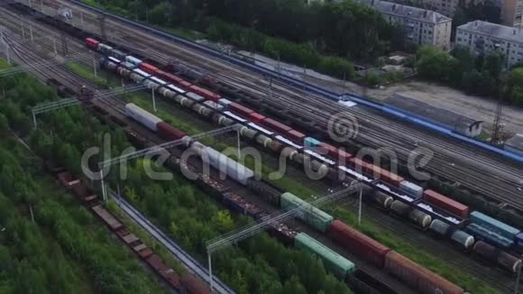 铁路列车在房屋背景上的俯视图录像货物过境的进出口视频的预览图