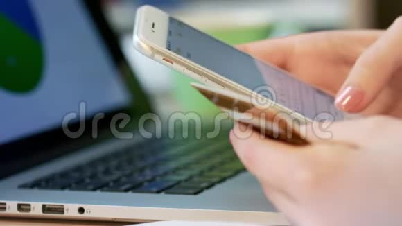 移动银行服务女性手在手机上打信用卡号码视频的预览图